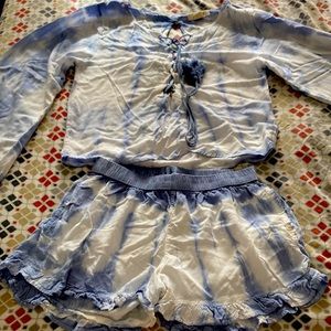 A two piece, blue and white shirt and shorts. Size is medium.